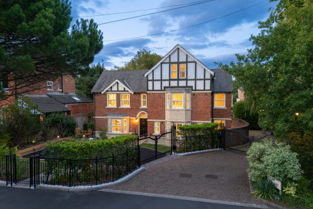 Detached mock Tudor family home with driveway and gates at 1 Holland Park, Bramhall