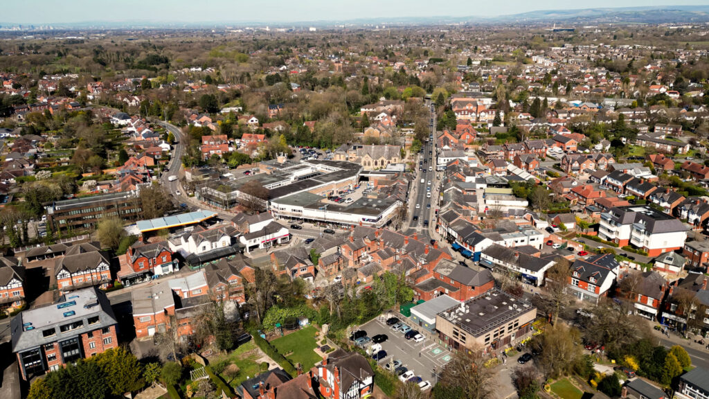 Aerial drone view of Bramhall village centre and surrounding homes